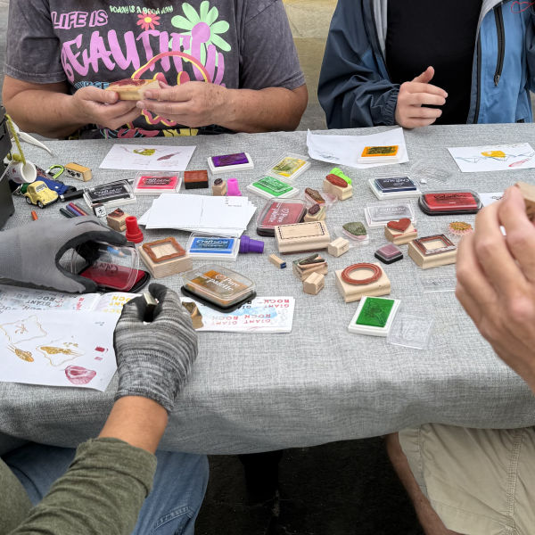 Rubber stamps array on table top for postcard contest